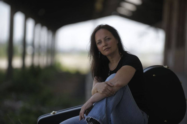 Sylkie Monoff - Die Singer-Songwriterin und Marketing-Expertin Sylkie Monoff mit ihrer Gitarre in einer alten Fabrikhalle